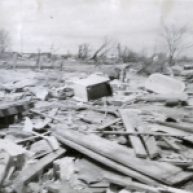 A dozen homes were completely leveled on the south side of Glazier. Here, one man picks through the rubble of his home. At right is the bathtub in which he rode out the storm.