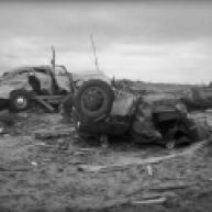 A number of vehicles were severely damaged in Glazier, and one person was killed when his car was thrown from the road. Also note the complete debarking and denuding of trees in the background, as well as debris granulation and possible ground scouring in the foreground.