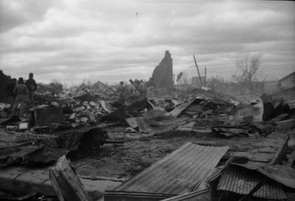 Rescuers search for victims in the rubble of brick buildings totally destroyed by the tornado and fire.